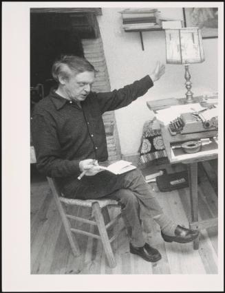 Portrait of writer Anthony Burgess at a desk