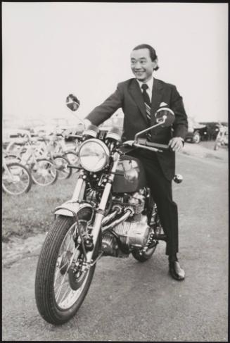 Kiyoshi Kawashima, president of Honda sitting on one of their motorbikes
