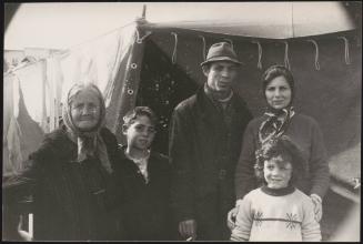 A family stand in front of temporary shelter in the aftermath of the Belice earthquake in Sicily 1968
