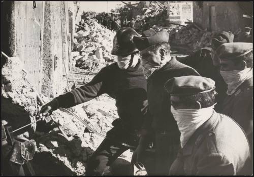 Soldiers and police work their way through rubble to find victims from the Belize earthquake in Sicily, 1968