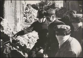 Soldiers and police work their way through rubble to find victims from the Belize earthquake in Sicily, 1968