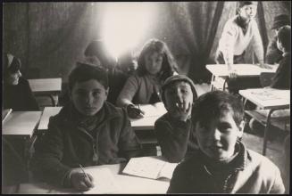 Children learning in a temporary shelter acting as a classroom in the aftermath of the destruction of many buildings during the Belize earthquake in Sicily 1968