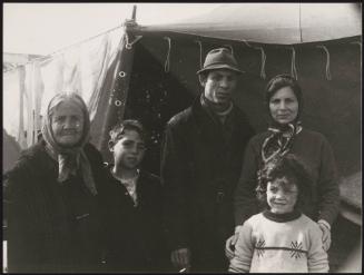A family stand in front of temporary shelter in the aftermath of the Belice earthquake in Sicily 1968