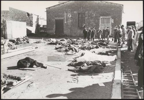 Victims form the Belice earthquake are laid out under blankets as survivors gather to pay their respects