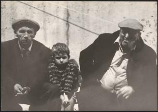Two men and a young boy sit in the Piazza Montecitorio in Rome the night of the Belice earthquake in 1968