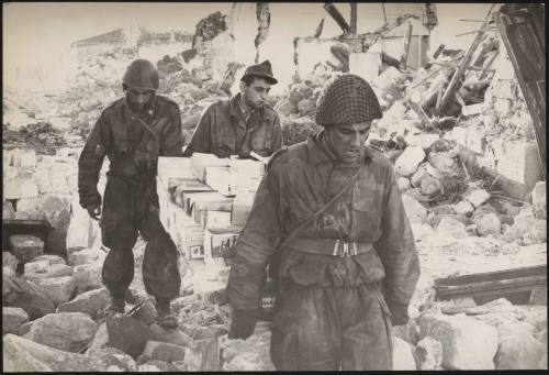 Soldiers being in rations and supplies to a town almost completely demolished by Belice earthquake in Sicily 1968