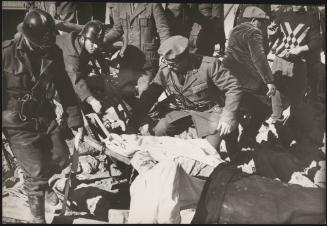 Police troops pull a victim out of the rubble during the aftermath of the Belice earthquake in Sicily 1968