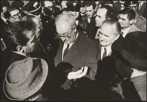 President of the Republic Giuseppe Saragat talks to other officials, uniformed police and displaced residents in Sicily after the Belice earthquake, 1968