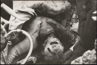 The body of a victim face down in rubble after the Friuli earthquake in Gemona de Friuli 1976 