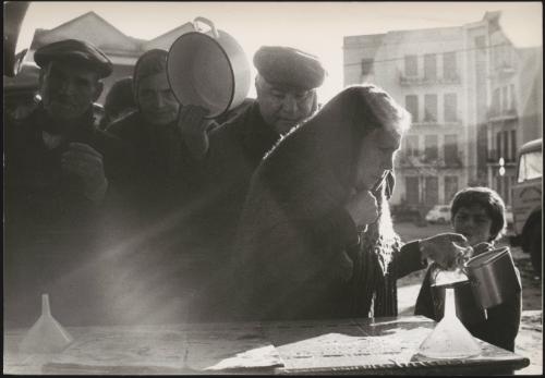 The displaced survivors of the Belice earthquake queue for provisions, Sicily 1968