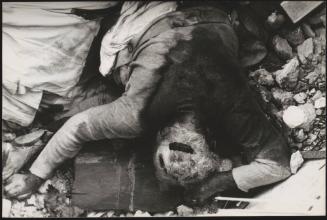 The body of a victim, face down in rubble, in the aftermath of the Friuli earthquake, 1976