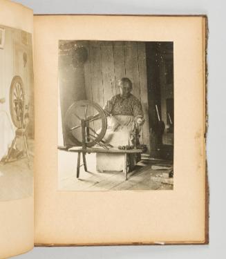 [Elderly woman at her spinning wheel] [Page 44 of Quebec I; from collection of Canadian albums compiled by Edith S. Watson, 1890s-1930s.]