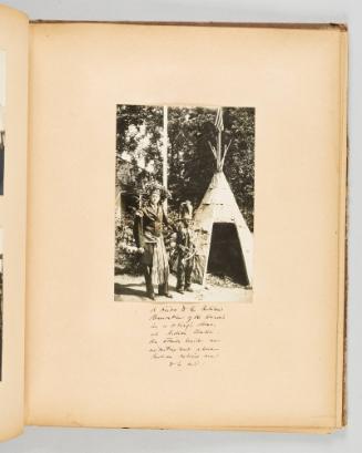 A visitor to the Indian Reservation of the Hurons in a chief's dress, at Indian Lorette. He stands beside an advertisement where Indian relics are to be had. Page 25 of Quebec II; from collection of Canadian albums compiled by Edith S. Watson, 1890s-1930s
