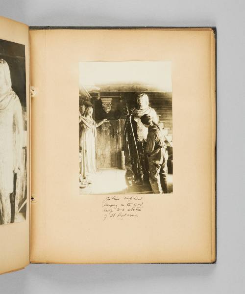 Jobin's nephew laying on the gold leaf to a statue of St. Octave. Page 59 of Ste Anne de Beaupré; from collection of Canadian albums compiled by Edith S. Watson, 1890s-1930s