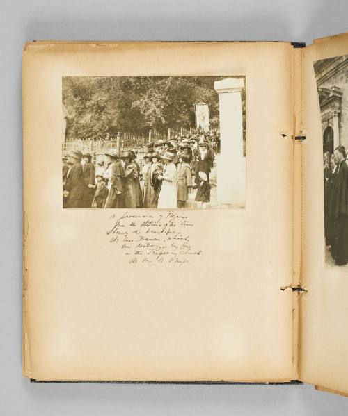 A procession of pilgrims from the Stations of the Cross showing the beautiful Ste. Anne Banner, which was destroyed by fire in the Temporary Church, Ste. Anne de Beaupré. Page 38 of Ste Anne de Beaupré; from collection of Canadian albums compiled by Edith S. Watson, 1890s-1930s