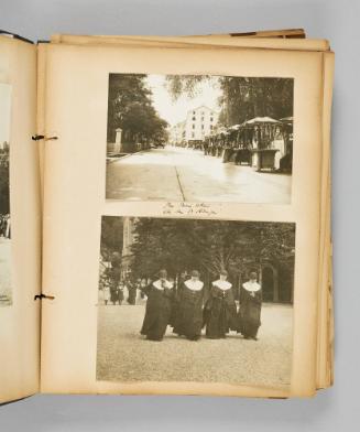 The Main street, Ste. Anne de Beaupré. [Tourist vendor carts selling pennant banners ; Four nuns walk in a line while one kisses a Bible] Page 15 of Ste Anne de Beaupré; from collection of Canadian albums compiled by Edith S. Watson, 1890s-1930s