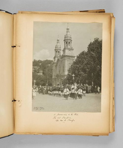 A procession in the Park, the old Basilica, Ste. Anne de Beaupré. Ste. Page 13 of Ste Anne de Beaupré; from collection of Canadian albums compiled by Edith S. Watson, 1890s-1930s