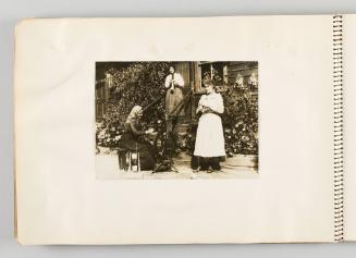 [Three women outside of home knitting and using spinning wheel, page 36 of The Doukhobors I album]