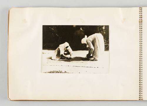 [Two women sorting grain on carpet, page 18 of The Doukhobors I album]