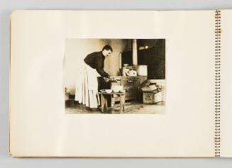 [Woman serving soup in kitchen, page 4 of The Doukhobors I album]