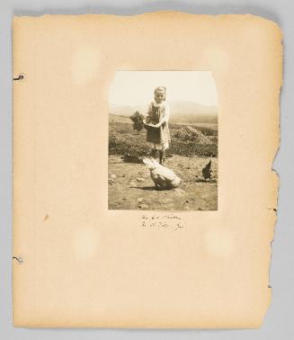 Her pet chicken, in St. Tils, Que. [Page 75 of Children album]

