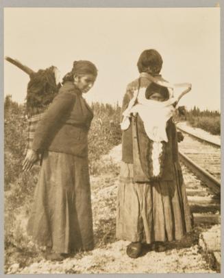 Cree babies tucked away in their gay-colored "tikinagans" at the Pas, Manitoba
