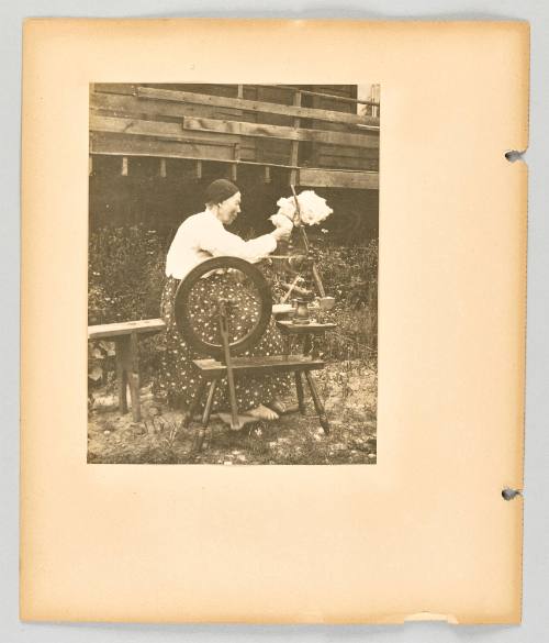 [Elderly woman spins flax yarn barefoot in the yard] [Page 24 of The Doukhobors II album]