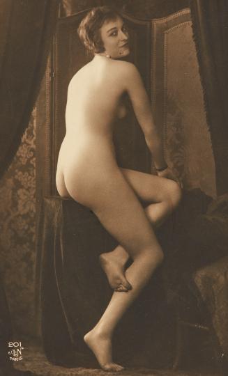 [Seated woman (looking over shoulder)]