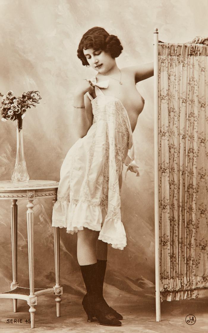 [Woman with screen and flowers on table]