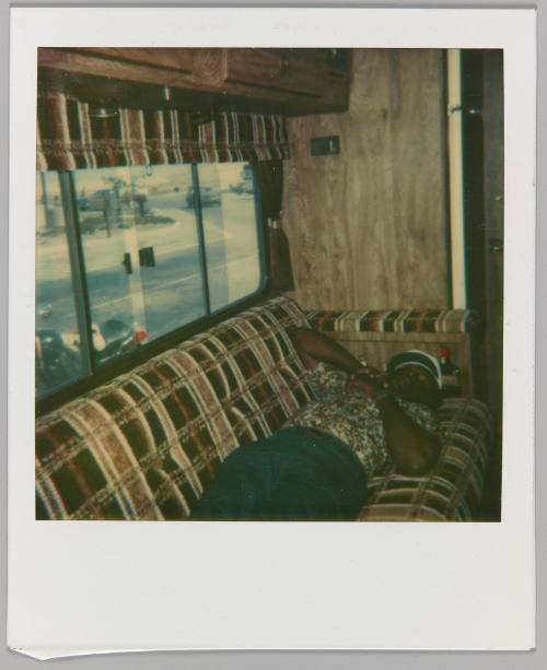 [Man sleeping on couch in RV]

