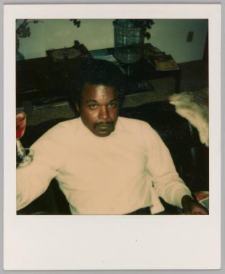 [Man with moustache holding glass of wine]
