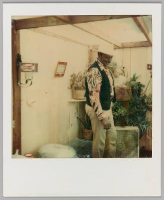 [Man in cowboy hat in greenhouse]
