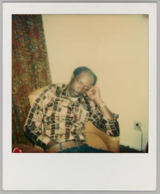 [Man asleep in arm chair with hand down his pants]
