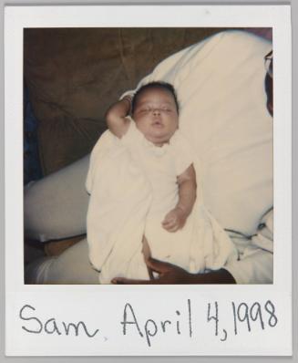 Sam, April 4, 1998 [sleeping baby in mans arms]