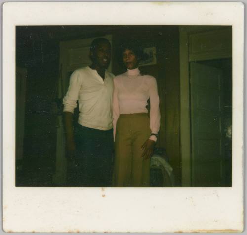 [Man in white polo and woman with pink turtleneck sweater posing side by side]
