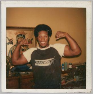 [Man in marathon shirt flexing his biceps]
