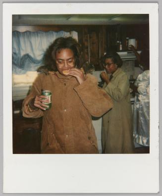 [Woman eating pastry and holding can of Mountain Dew soda]
