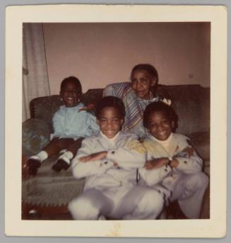 William [Two boys in matching outfits with young girl and elderly woman on couch]
