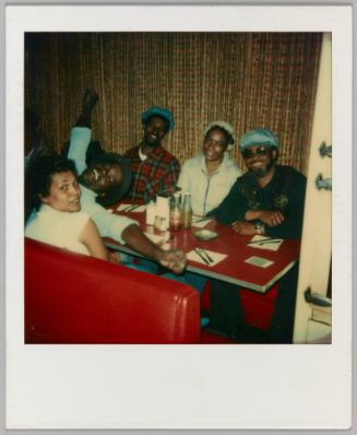 [Three men and two women sitting at a diner]

