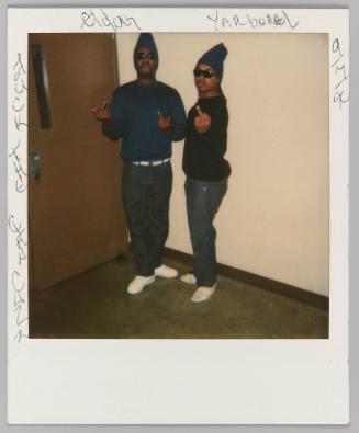 Eldog, Yarborel, Fuck The Clan Cuzz [Two men dressed in black flipping off the camera]
