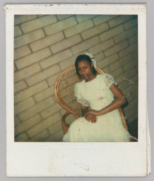 [Teen girl posing in wicker chair in white lace dress]
