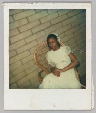 [Teen girl posing in wicker chair in white lace dress]
