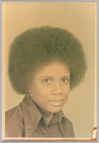 Yvonne, To the coolest sister in the world with the most out of sight personality [Headshot of woman with afro, hoop earrings, and collared shirt]