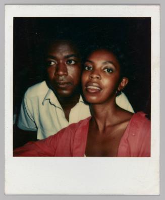 [Man and woman posing cheek to cheek, woman looking into camera]
