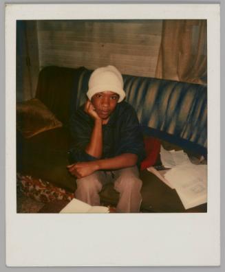 Eric Scott/ Vernon Lee son [Teenage boy in white hat sitting on couch, he is resting his chin on his hand]