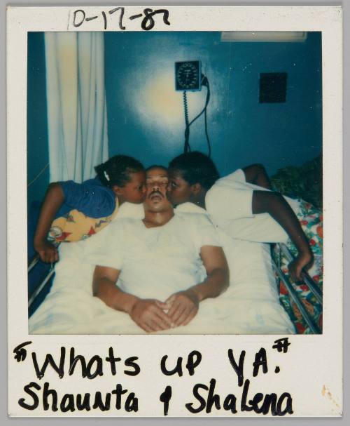 "Whats up ya." Shaunta + Shalena 10-17-87 [Man sleeping in hospital bed with two girls on either side of him kissing his cheek]