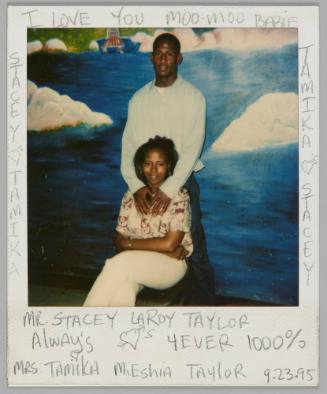 Mr Stacey LaRoy Taylor Always [heart] 4Ever 1000% Mrs Tamika Mieshia Taylor 9.23.95 [Woman sitting with legs crossed, man standing behind her with his hands on her shoulder, wall mural behind them]