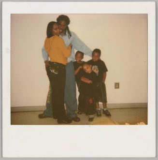 "1 - 17 - 09" [Man with his arm around a woman and three kids, woman is on left in a yellow top with a hood]