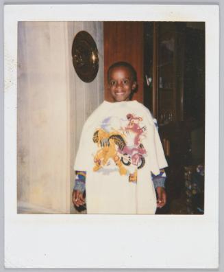 [Little boy wearing oversized Power Range tshirt smiling]