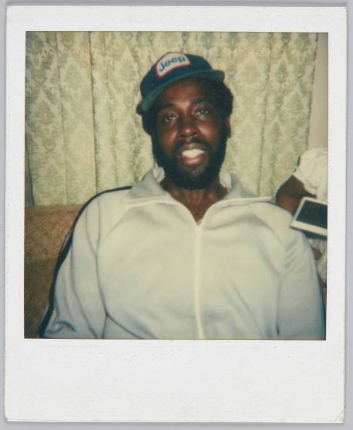 [Close up of man wearing 'Jeep' hat and zip-up sweater]